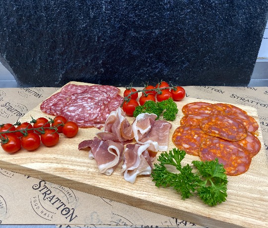 Delicious Cheeses available from Stratton Food Hall Platter of different cheeses decorated with fruit